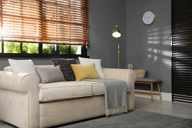 Stylish living room interior with comfortable sofa near window, Can Blinds Between Glass Be Repaired [Inc. Broken String, Changing Snap-In, And Uneven Blinds]?