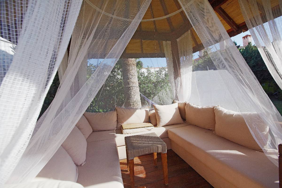 Put Weights At The Hem - Luxury modern gazebo with soft furniture and curtains inside garden surrounded with palms