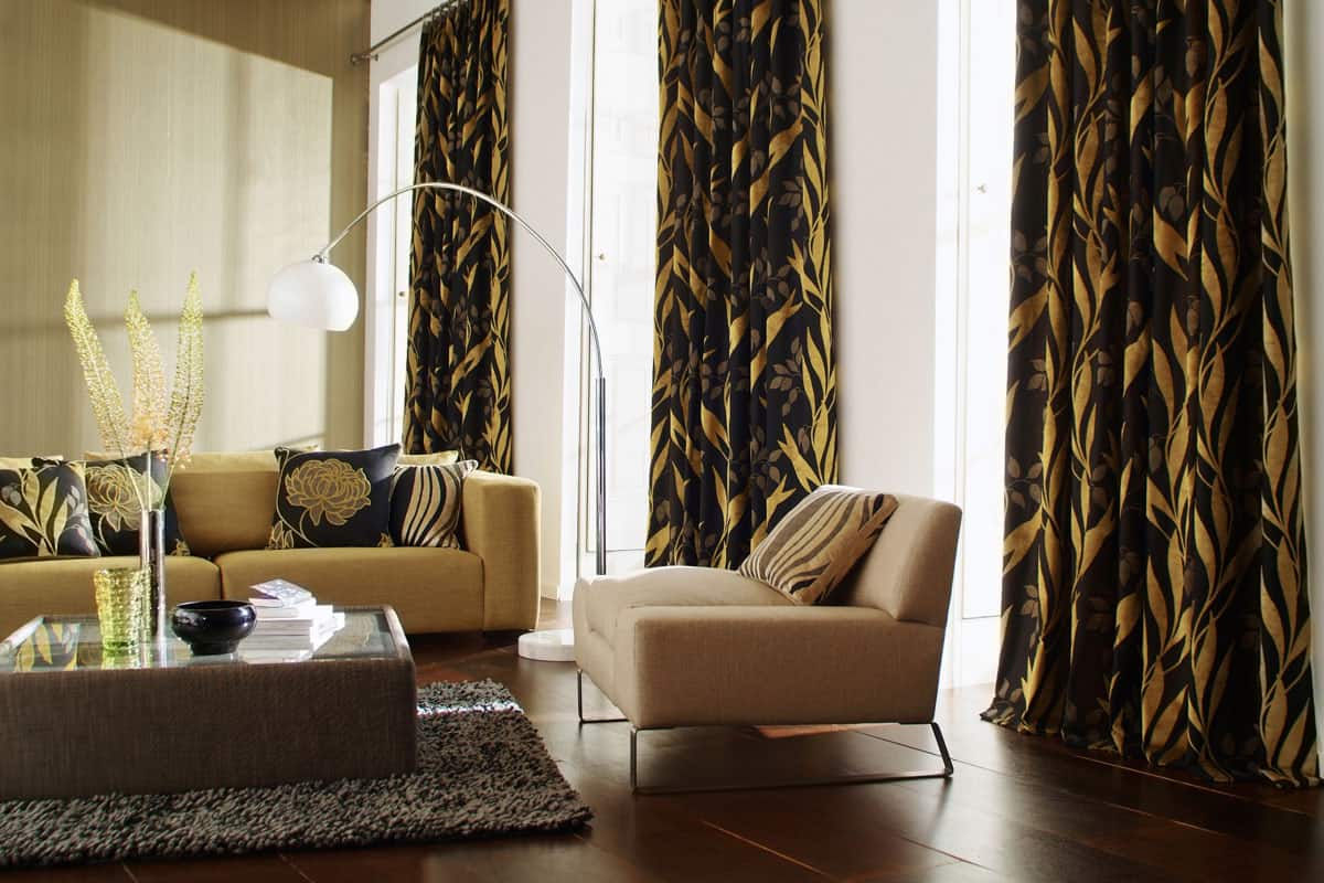 photo of an elegant living room with long curtain on wide window