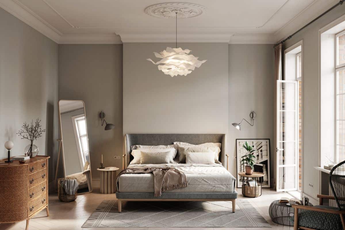 3D rendering of small bedroom with natural light. Computer generated image of elegant bedroom interiors with double bed, side cabinet and mirror on side.

