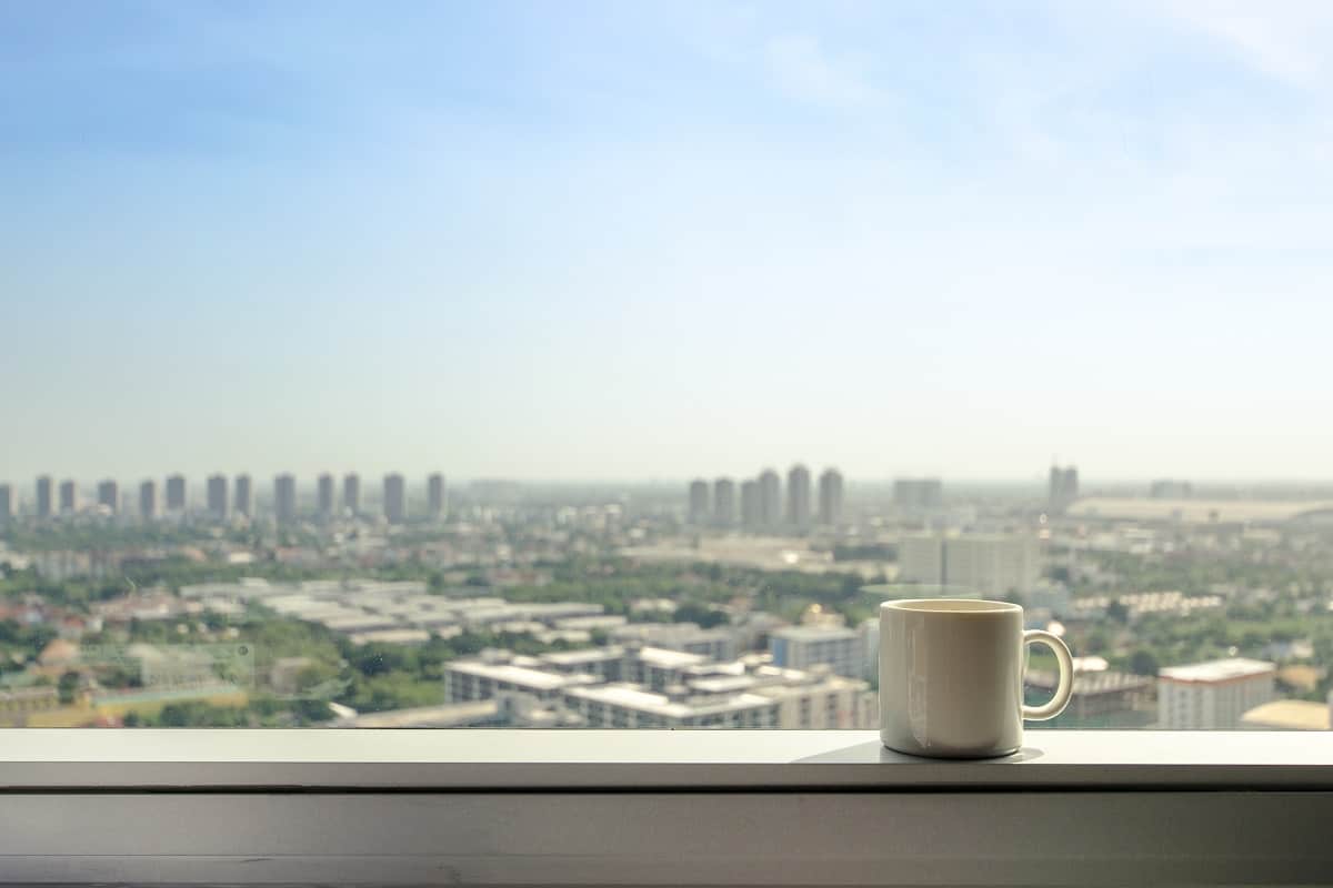 A Coffee Place - brake time with a mug of coffee and city view though window