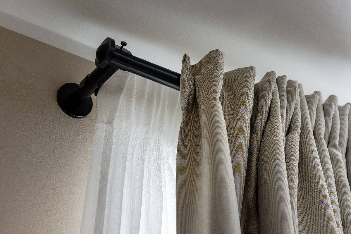Double layer curtains on black rod in living room