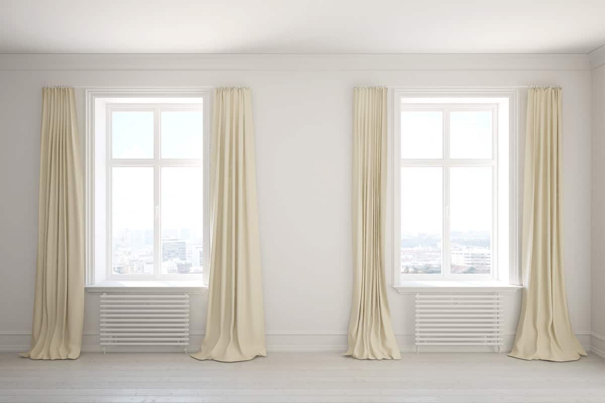 Empty room with long curtains on the windows