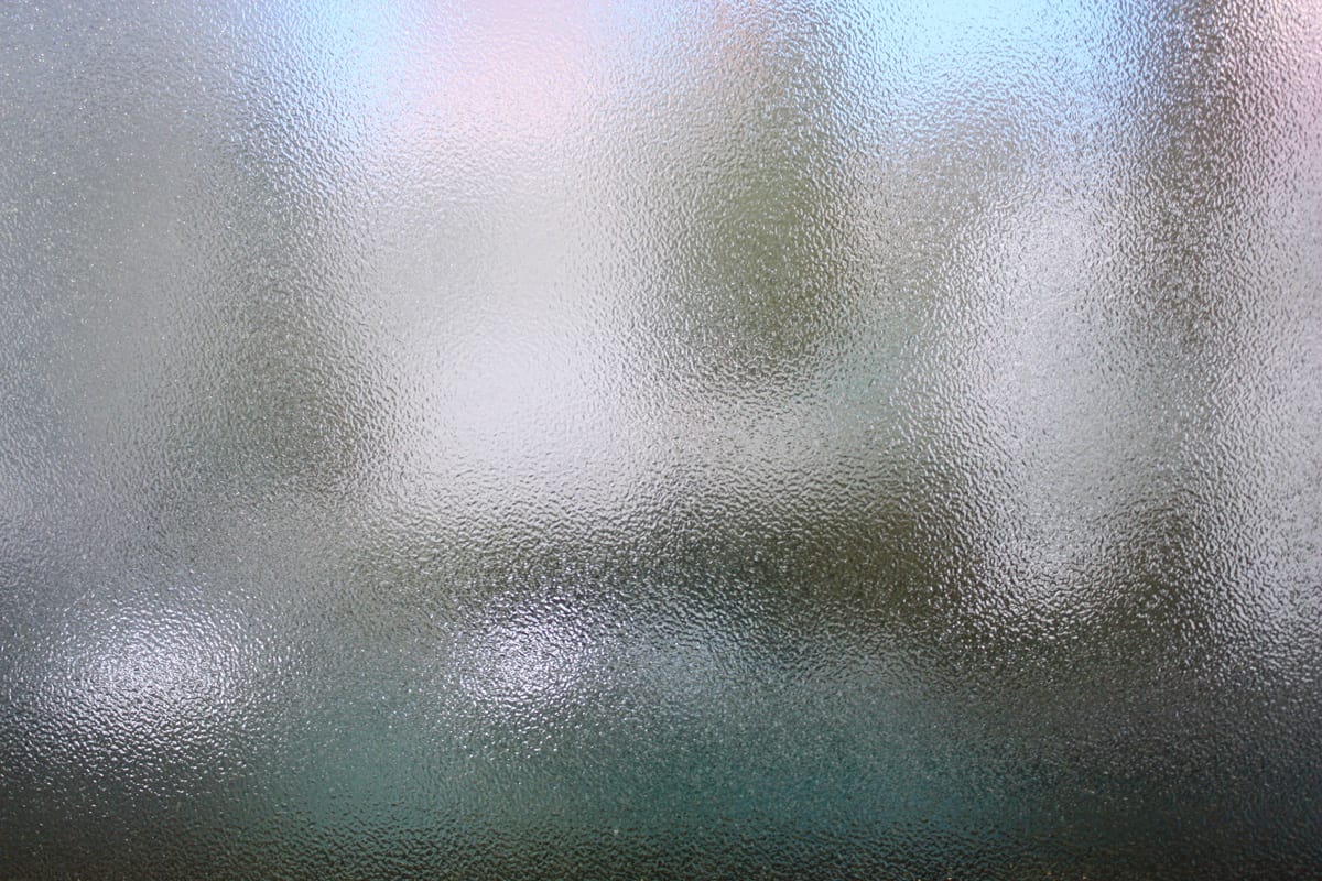 Frosted glass texture. Colorful lights background.