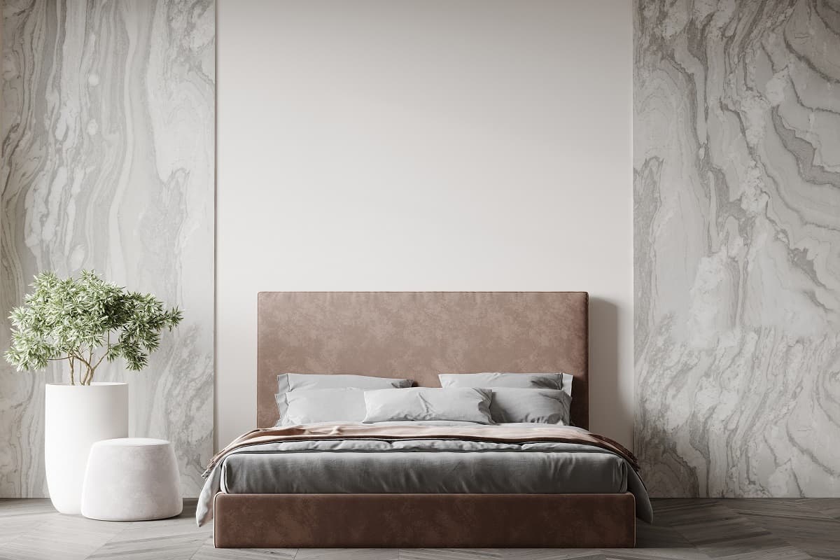 Luxurious large bedroom with marble slabs and a bed in the center. Delicate beige colors - ivory, milk, brown, taupe