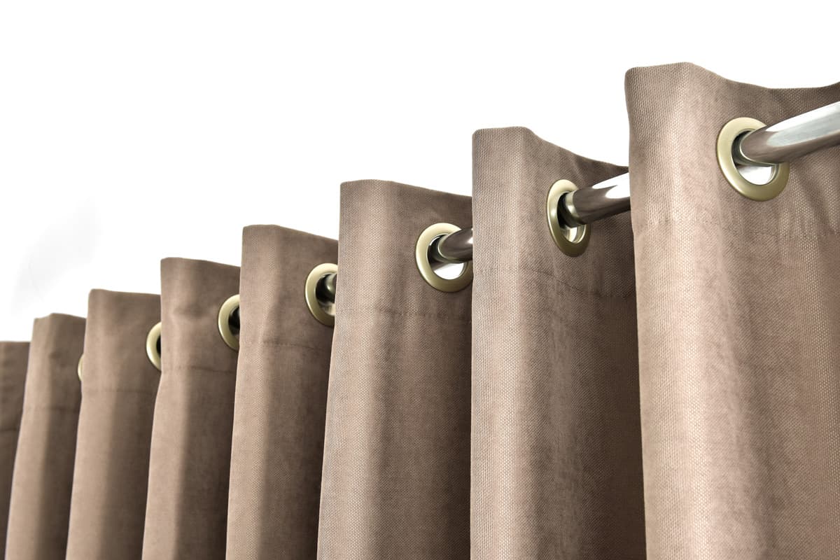 Modern brown drapes on the grommets. Eyelet curtains for home