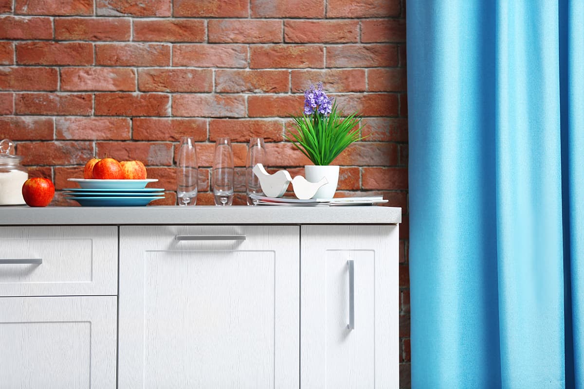 Modern kitchen furniture against brick wall