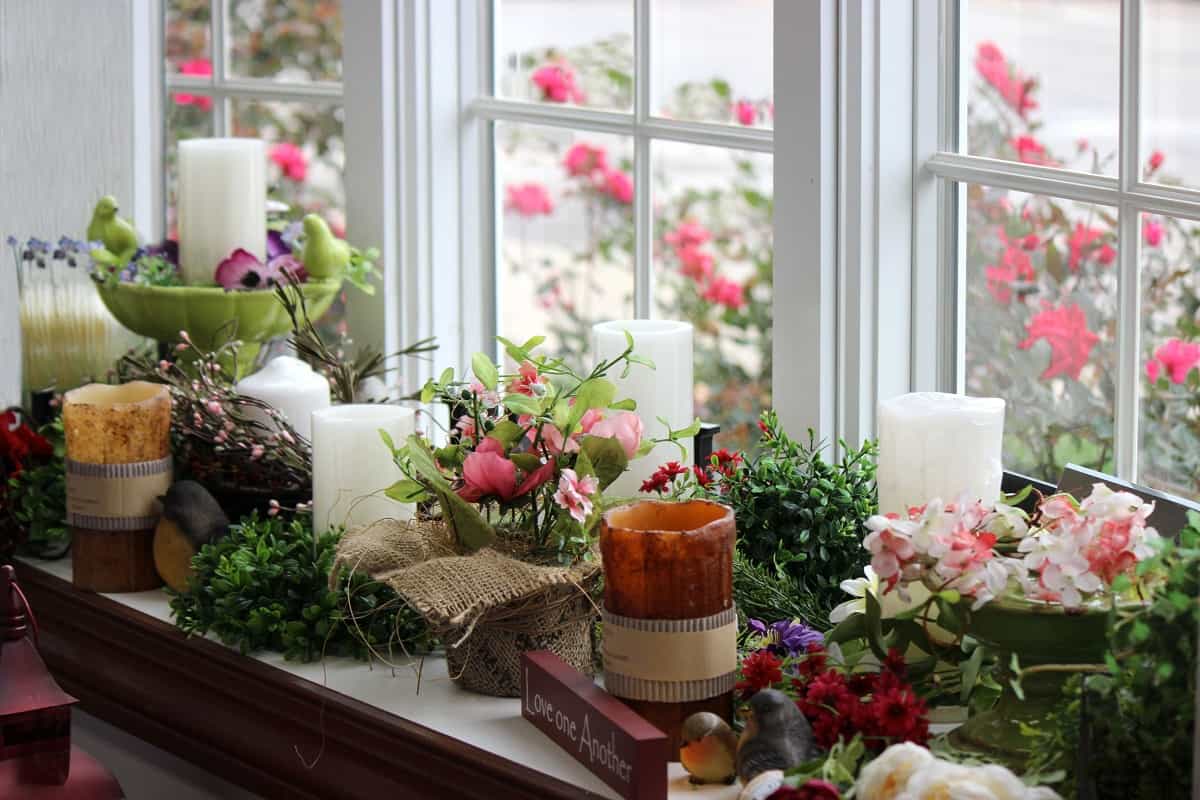 Romantic View - Beautiful photo of candles, candlestick holders, flowers, vases, wreaths, plants, birds and gifts on a window seat