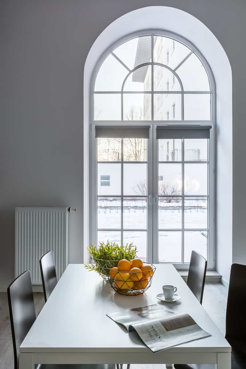 Standalone Half Circle Window - White dining room with half circle window, table and chairs