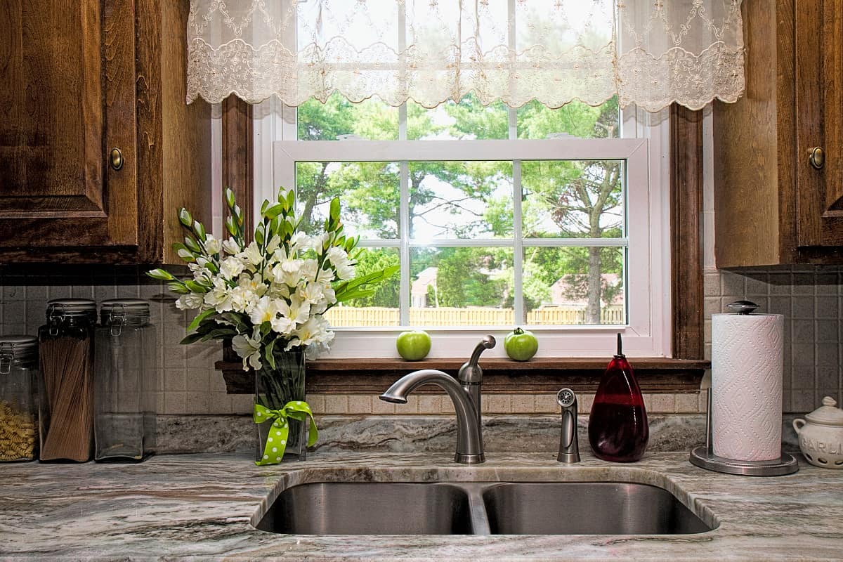Use Sheer White Curtains - View of Kitchen sink, window view of backyard, curtains and flowers.