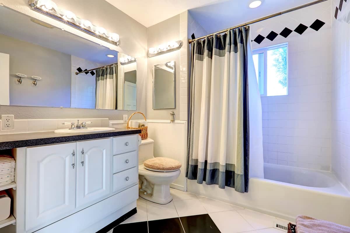 Where To Place Shower Curtains - Refreshing bright bathroom with white cabinet, bath tub and white curtain