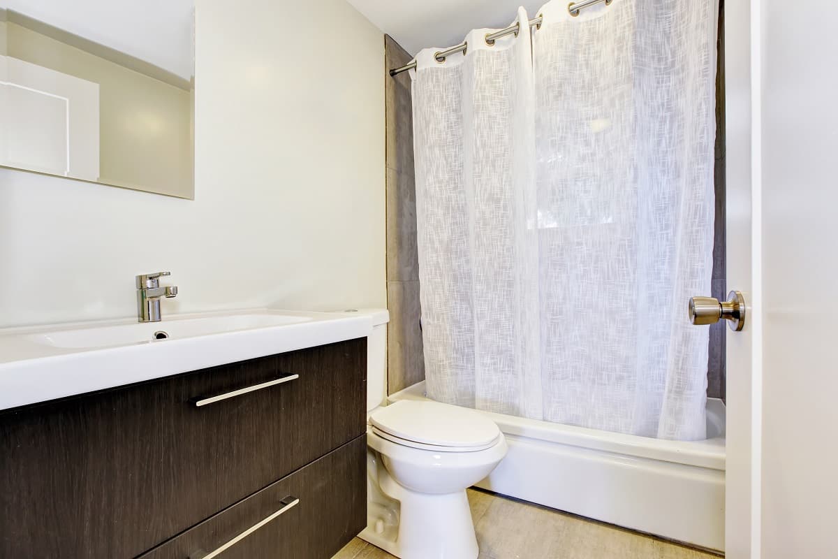 Why Is It Important To Always Leave Shower Curtains Closed - Bathroom interior with vanity cabinet and white shower curtain.