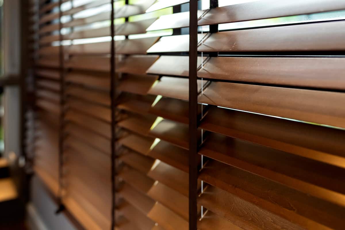 Wooden window shutter blind with light from sun home interior concept .