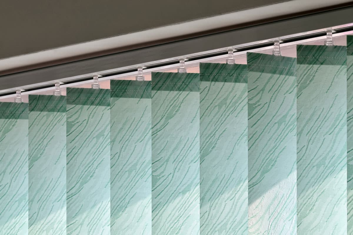 close up photo of a curtain vertical blinds color green