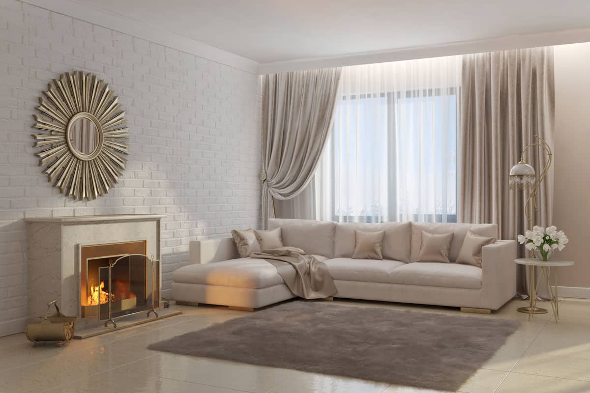 bright and cozy living room with fireplace and mirror